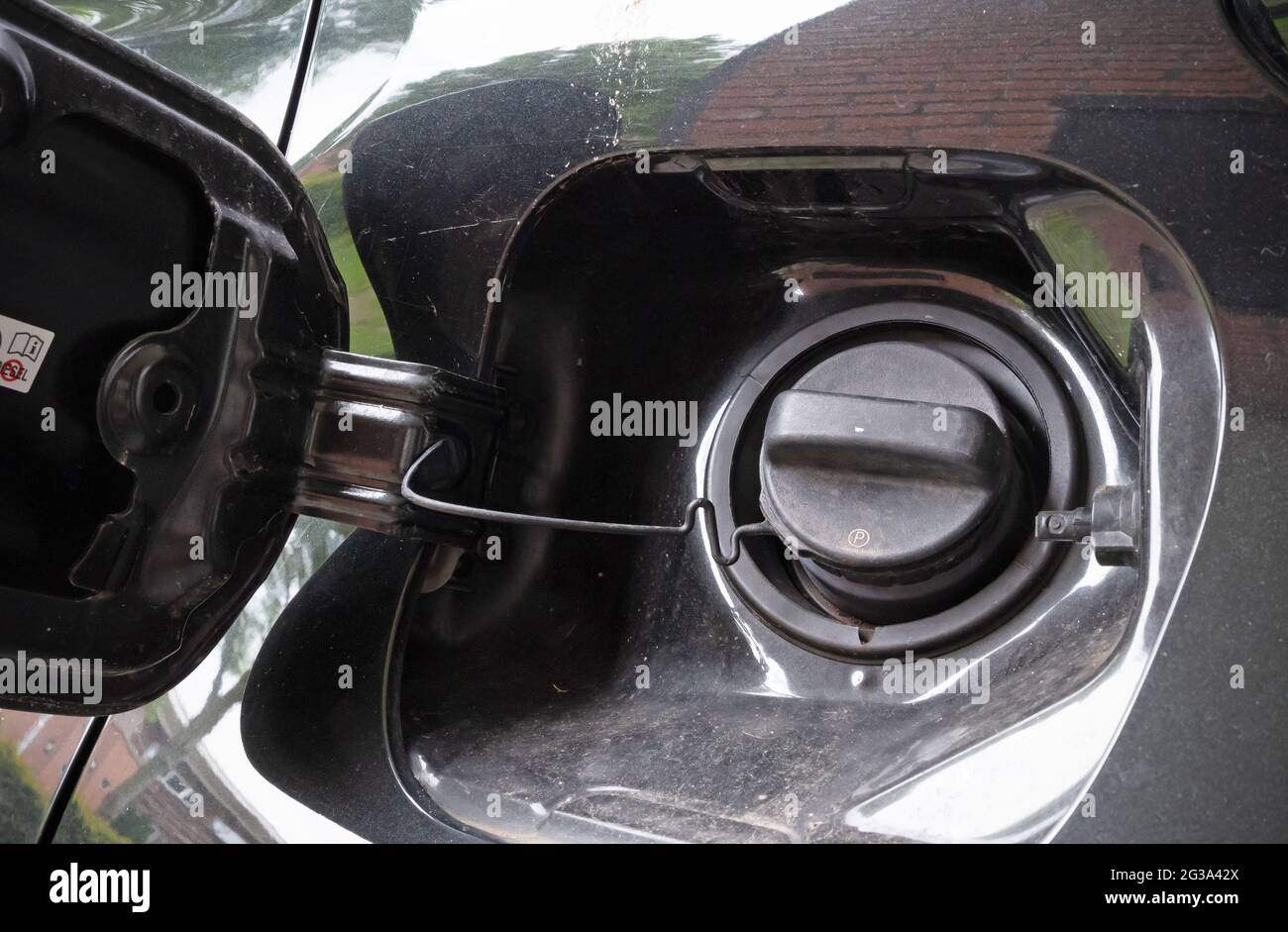 Car vehicle`s fuel cap or petrol tank cover, ready to be opened Stock